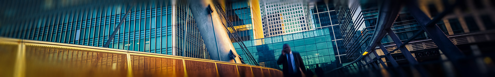 businessman walking in a city with a skyscraper in the background